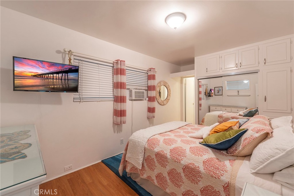 1728 The Strand, Unit 1 Hermosa Beach, CA 90254 - Photo 13 of 16 a bedroom with a bed and a window