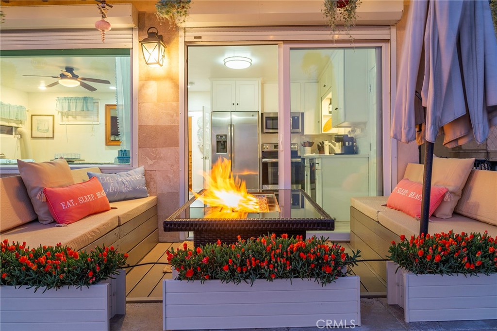 1728 The Strand, Unit 1 Hermosa Beach, CA 90254 - Photo 5 of 16 a living room with furniture and a large window