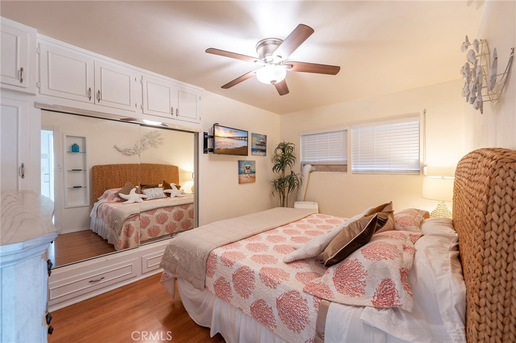 1728 The Strand, Unit 1 Hermosa Beach, CA 90254 - Photo 8 of 16 a bedroom with a bed and window