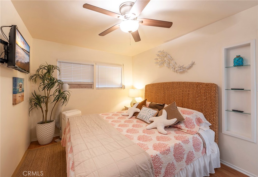 1728 The Strand, Unit 1 Hermosa Beach, CA 90254 - Photo 9 of 16 a bedroom with a bed and a chandelier