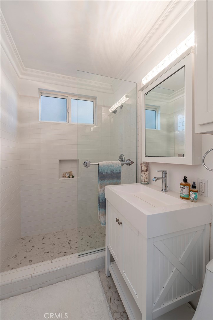 1728 The Strand, Unit 1 Hermosa Beach, CA 90254 - Photo 10 of 16 a bathroom with a sink a toilet and shower