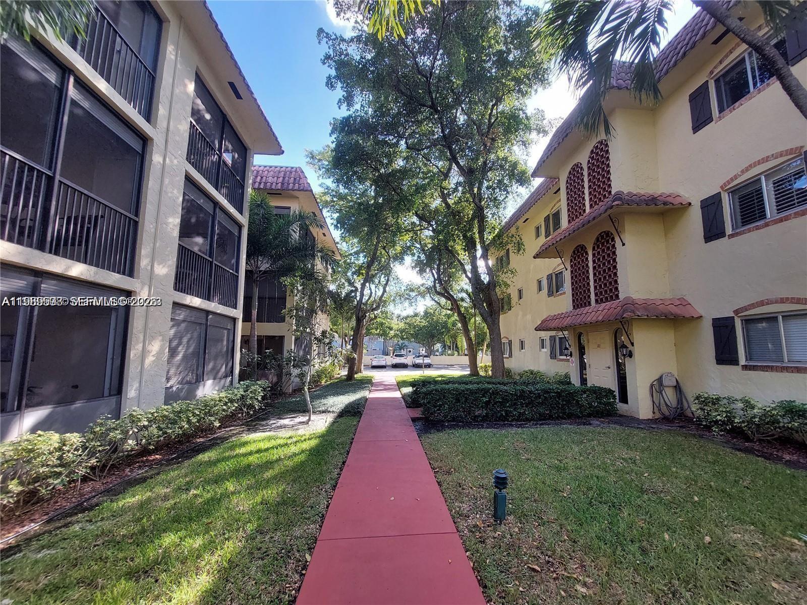 253 South Cypress Road, Unit 214 Pompano Beach, FL 33060 - Photo 16 of 25 a front view of a house with a yard