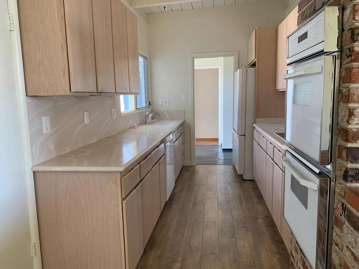 1170 Oakwood Drive Millbrae, CA 94030 - Photo 5 of 13 a kitchen with a sink stove and refrigerator