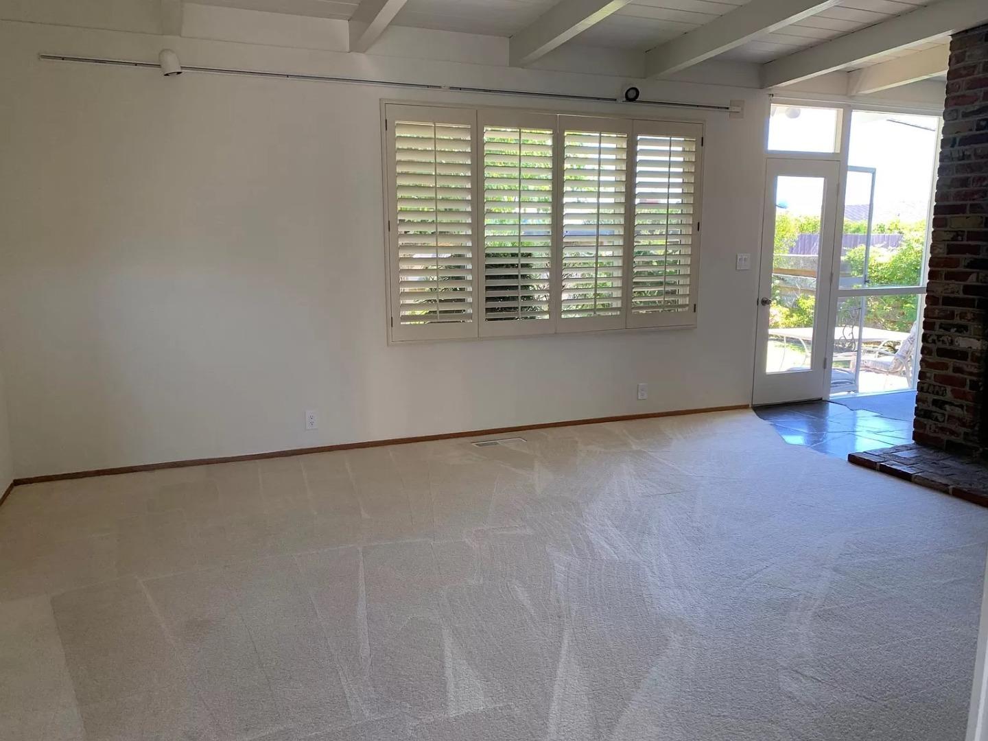 1170 Oakwood Drive Millbrae, CA 94030 - Photo 6 of 13 a view of an empty room with a fireplace and a window