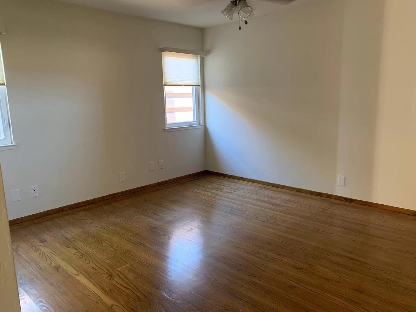 1170 Oakwood Drive Millbrae, CA 94030 - Photo 9 of 13 a view of an empty room with wooden floor and a window