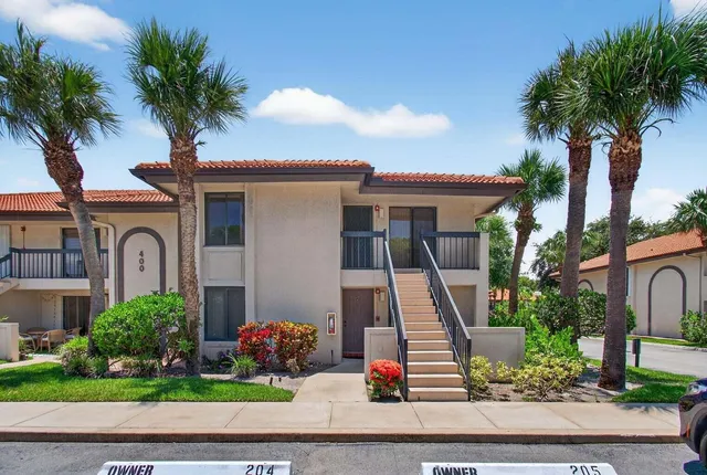 a living room with furniture floor to ceiling window and wooden floor