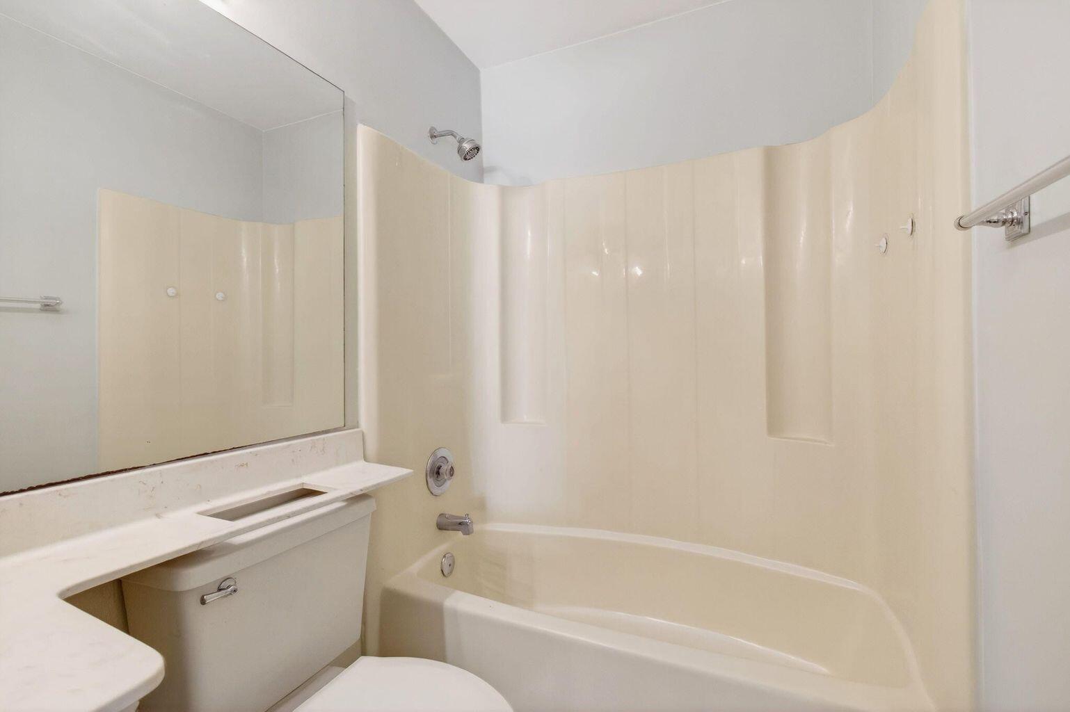 400 Club Circle, Unit 201 Boca Raton, FL 33487 - Photo 36 of 64 a white bath tub sitting next to a white toilet