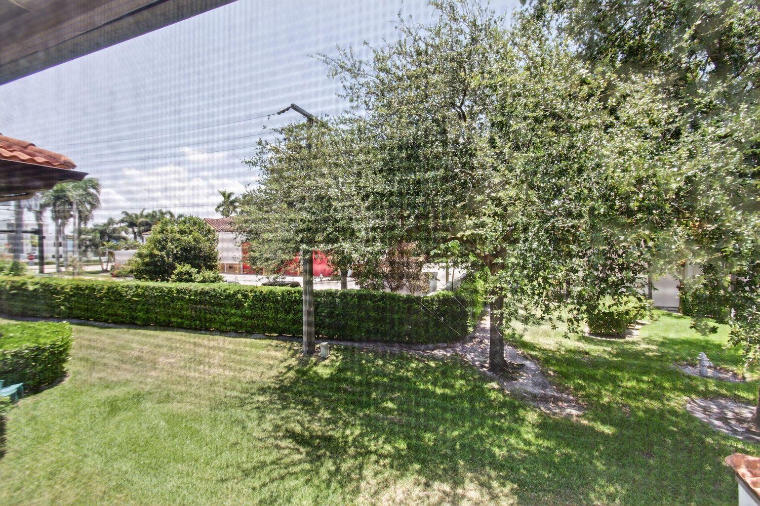 400 Club Circle, Unit 201 Boca Raton, FL 33487 - Photo 55 of 64 a view of a house with a tree and a yard