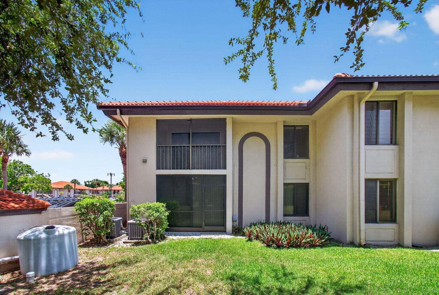 400 Club Circle, Unit 201 Boca Raton, FL 33487 - Photo 60 of 64 a front view of a house with a yard