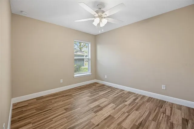 wooden floor in an empty room with a window