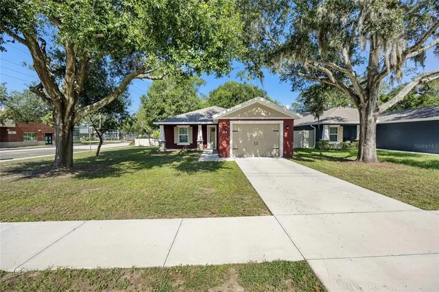 a front view of a house with a garden