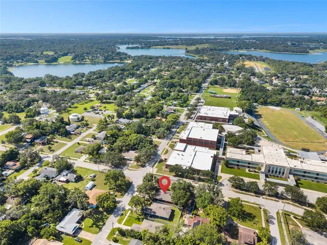 an aerial view of residential building and lake