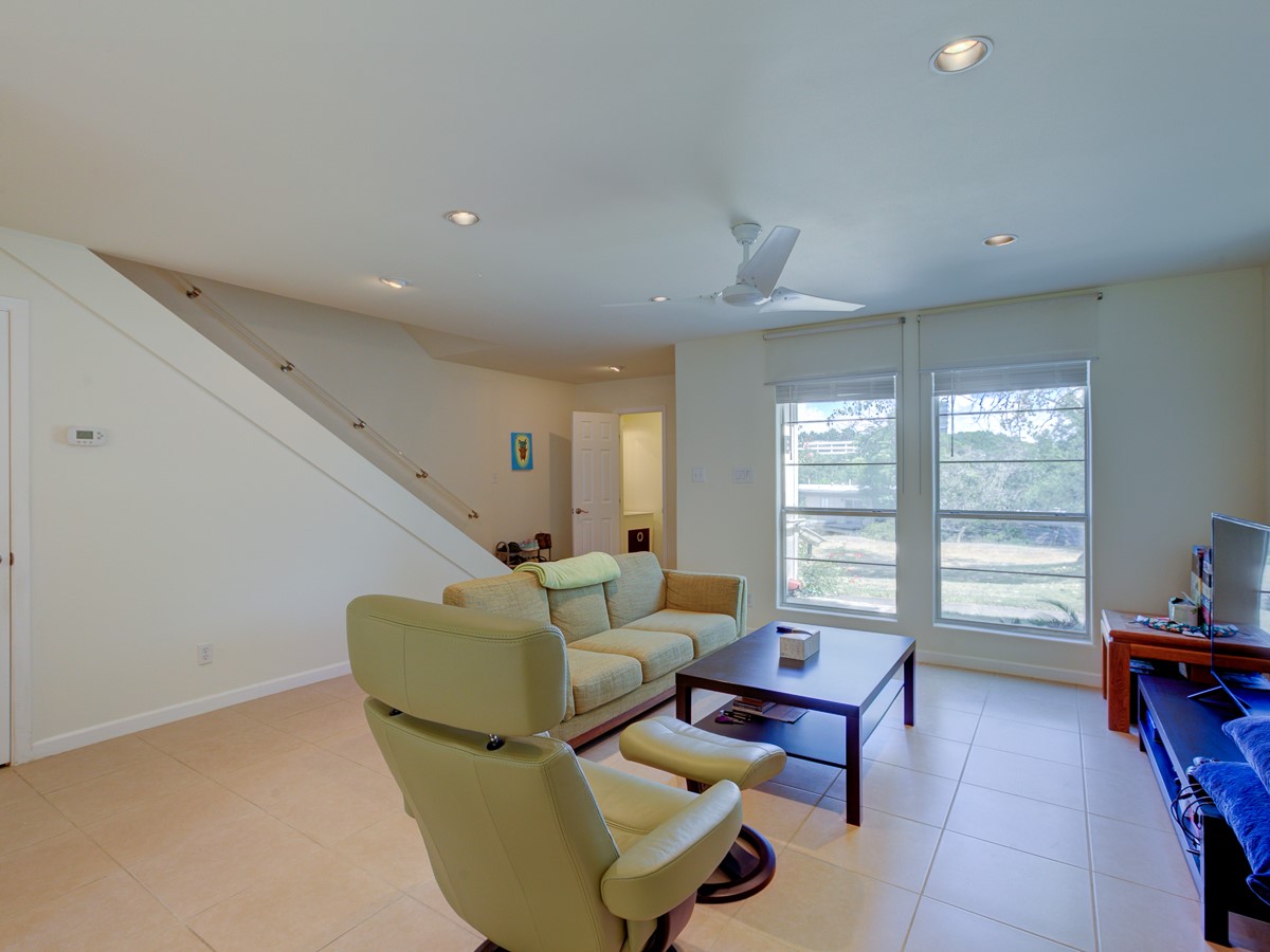 710 Castle Ridge Road, Unit B Austin, TX 78746 - Photo 14 of 27 Sun-filled living space with ample natural light from generous windows and ceramic tile underfoot.