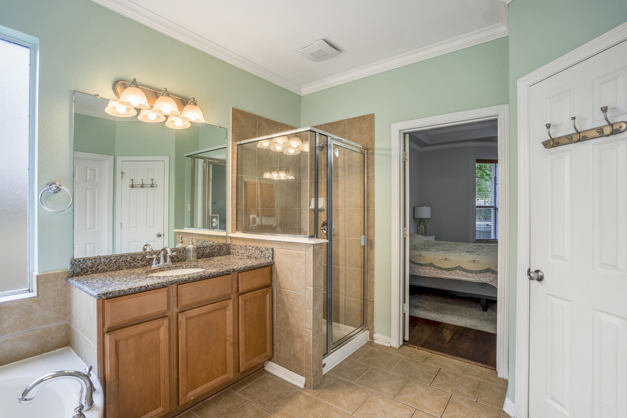 10410 Pitcataway Drive Spring, TX 77379 - Photo 20 of 48 The en-suite features two vanity areas, with granite countertops, ample cabinetry and glass enclosed shower.