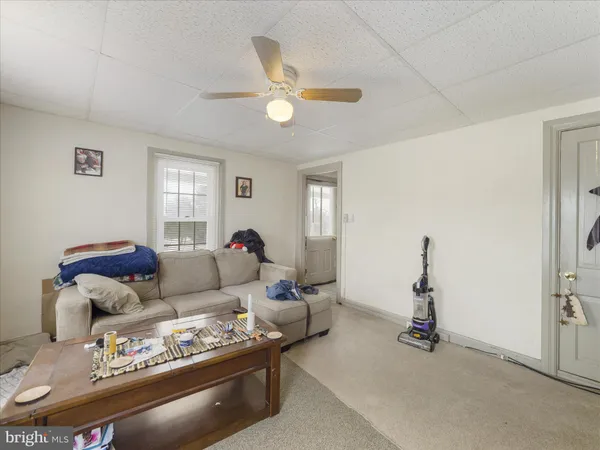 a living room with furniture a window and a chandelier
