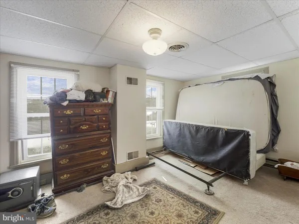 a living room with a couch and a dresser