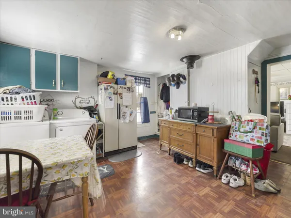 a room with furniture a rug toys and a window