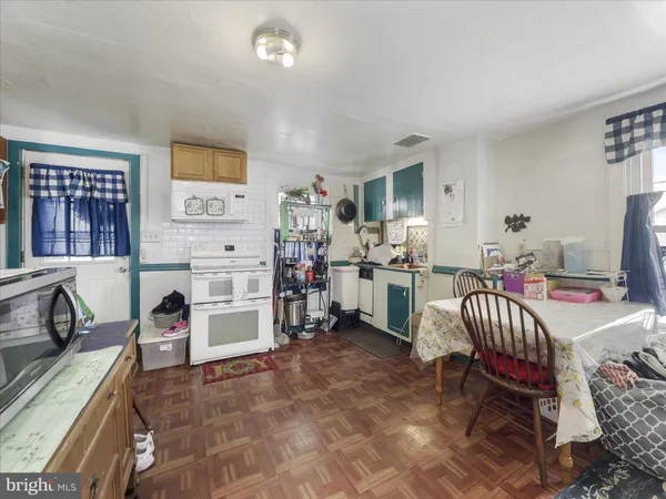 a living room with furniture and a baby crib