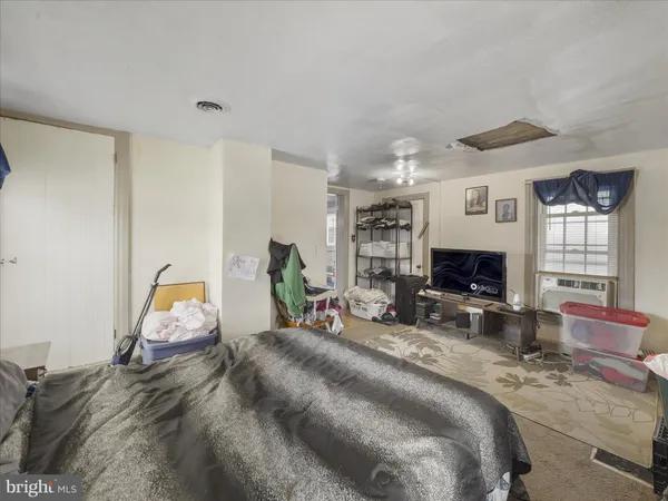 a bed room with furniture and a flat screen tv