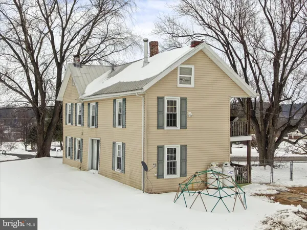 a view of a white house with a yard