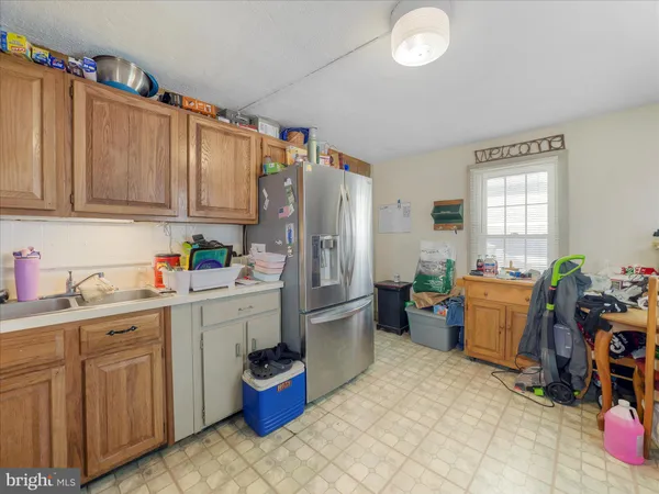 a kitchen with a refrigerator and sink