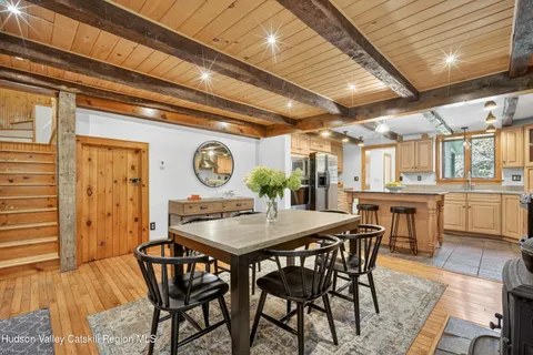 a dining room with a wooden table and chairs