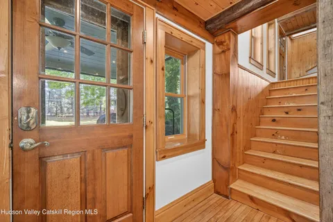 a view of front door with wooden floor and a window