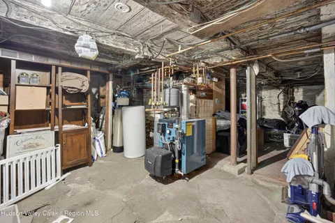 an aerial view of residential house with outdoor space and trees all around