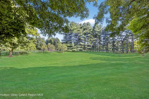 a view of a grassy field with trees