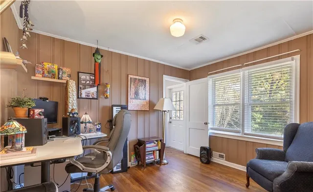 a view of a workspace with furniture and a window