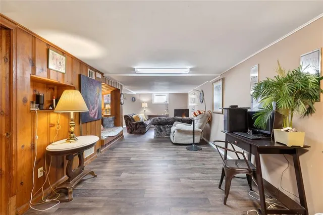 a living room with furniture kitchen view and a large window