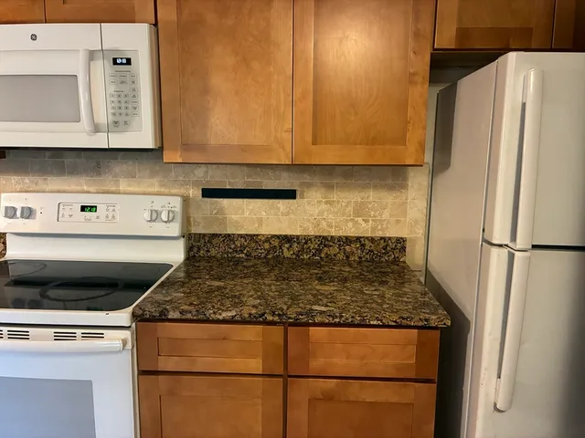 a kitchen with kitchen island a counter top space and cabinets