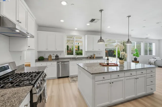 a kitchen with a sink stove and cabinets