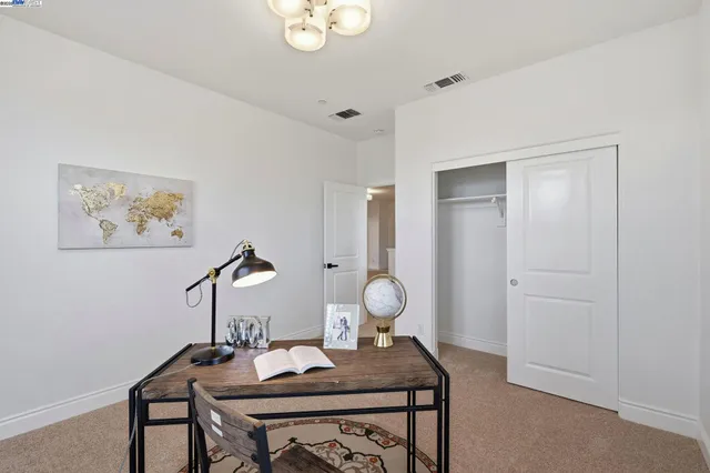 a view of a workspace room with furniture and wooden floor