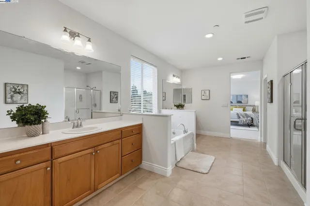 a hall with a sink and a large mirror