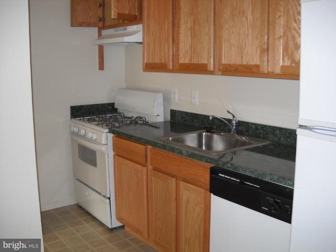 3814 Bel Pre Road, Unit 359 Silver Spring, MD 20906 - Photo 2 of 8 a kitchen with granite countertop stainless steel appliances a sink stove and cabinets