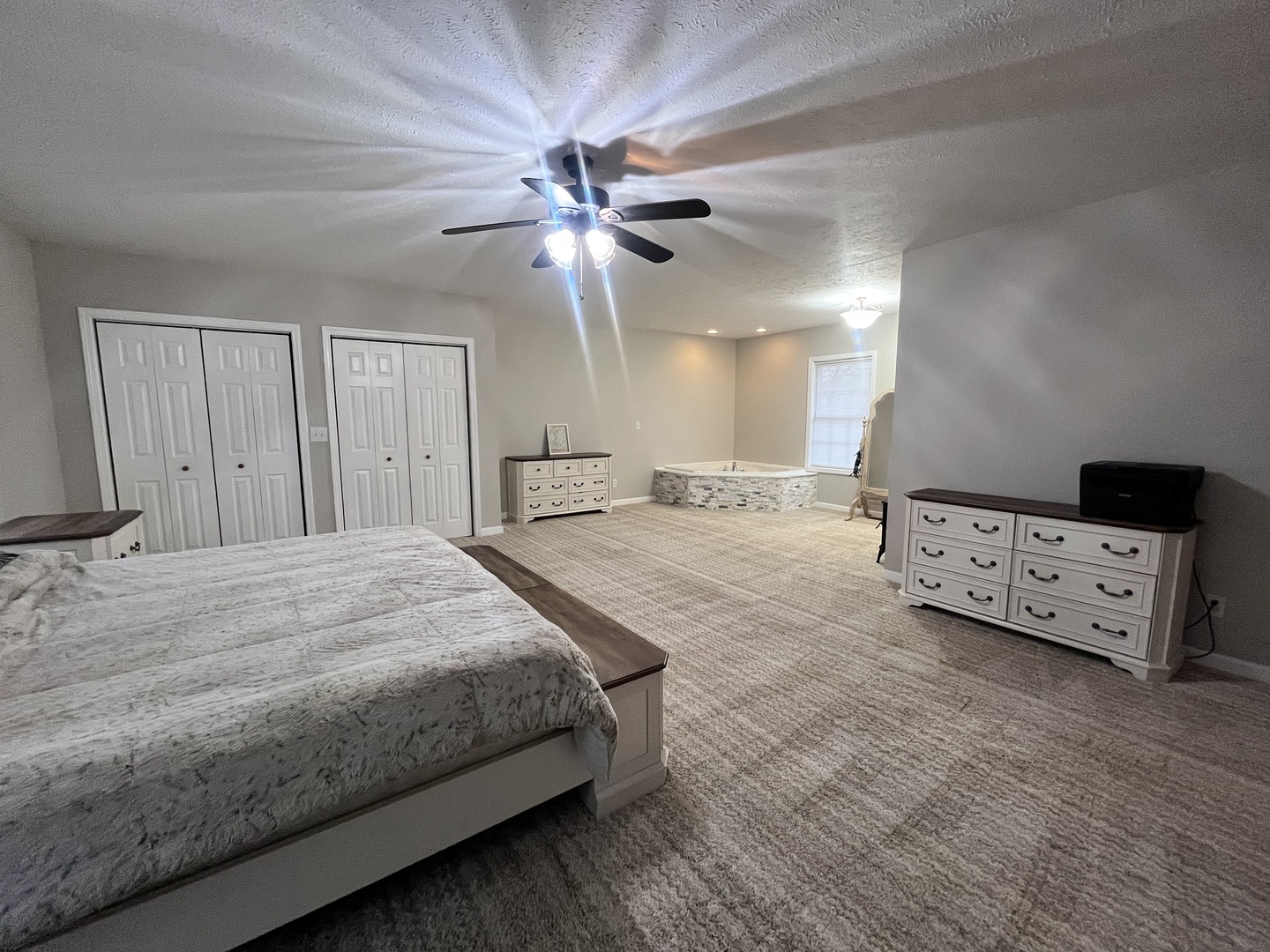 5488 Tick Ridge Road Grand Chain, IL 62941 - Photo 27 of 55 a spacious bedroom with a bed and a chandelier