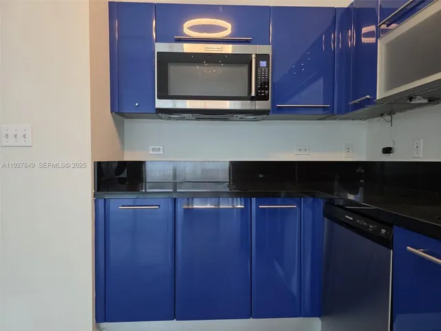 a kitchen with stainless steel appliances granite countertop wooden cabinets and a stove top oven