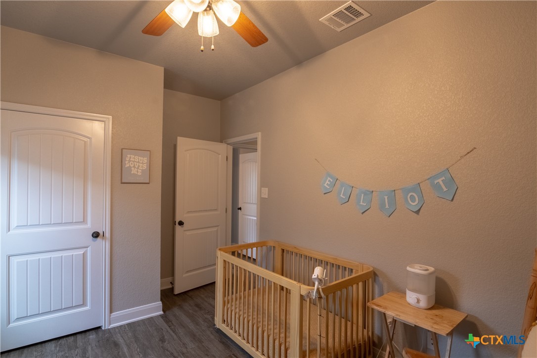 7909 McCulloch Road Temple, TX 76502 - Photo 5 of 46 a bedroom with a bed and wooden floor
