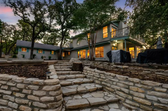 a view of a backyard with swimming pool