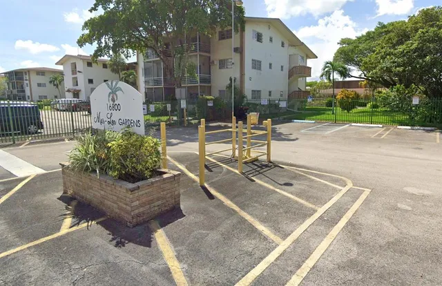a view of a patio with couches and table with potted plants