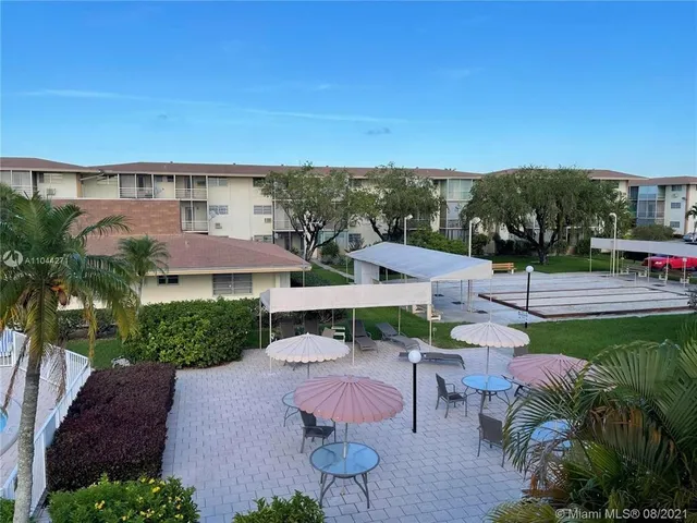 a view of a patio with furniture and a yard