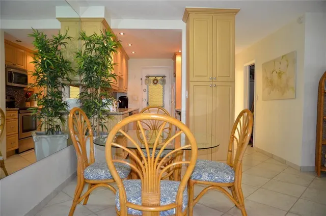 a view of a dining room with furniture and a potted plant