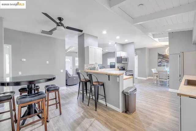 a large kitchen with a table and chairs in it