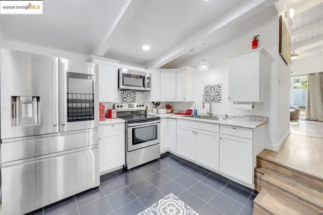 a kitchen with a sink stove and cabinets