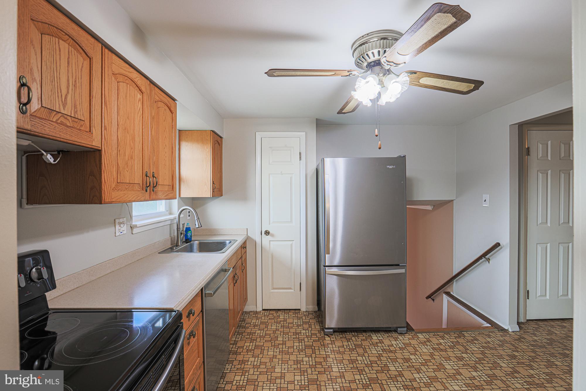 3923 Millner Road Baltimore, MD 21236 - Photo 13 of 38 a kitchen with stainless steel appliances a refrigerator a sink a stove a table and chairs