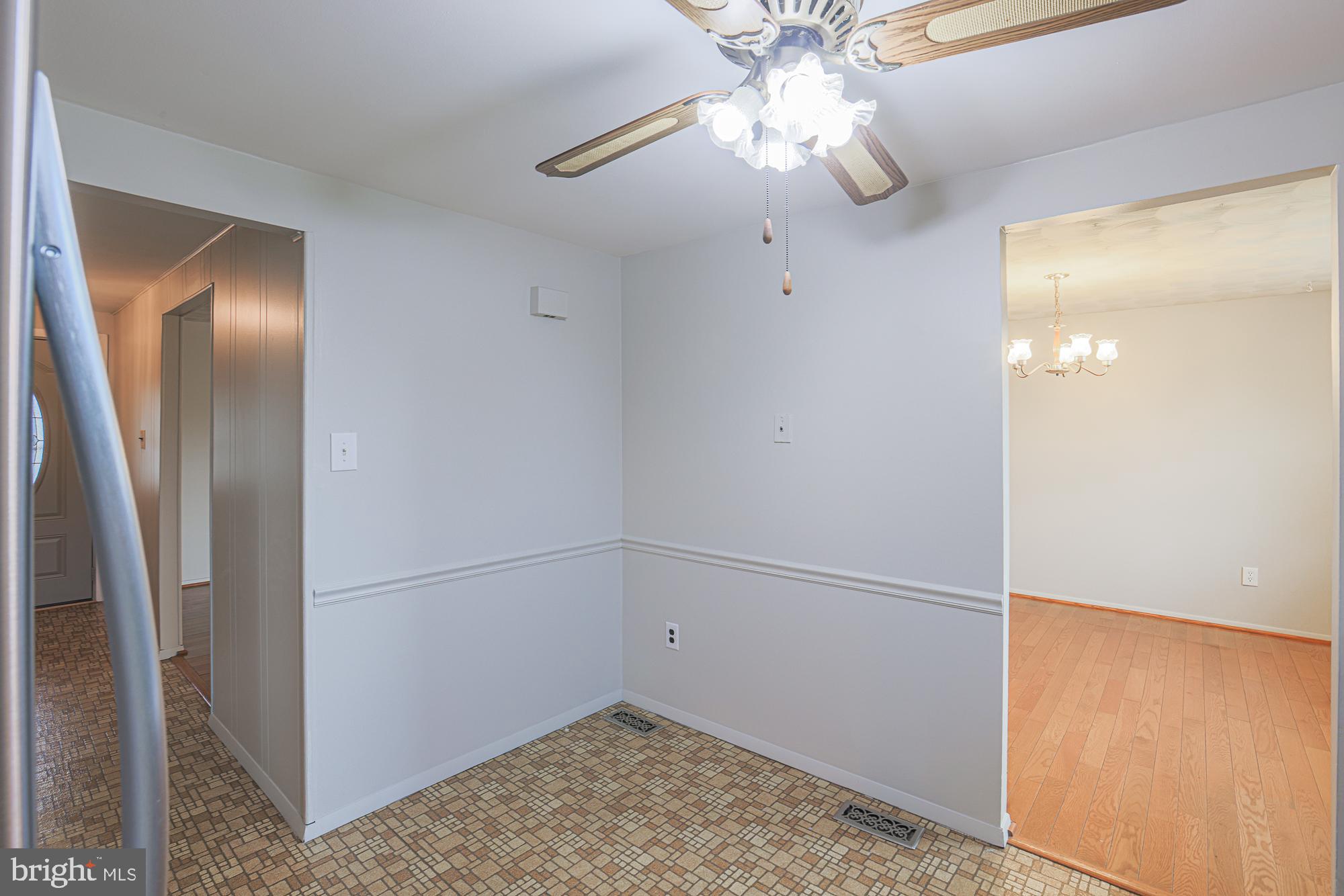 3923 Millner Road Baltimore, MD 21236 - Photo 14 of 38 a view of a hallway with a chandelier fan