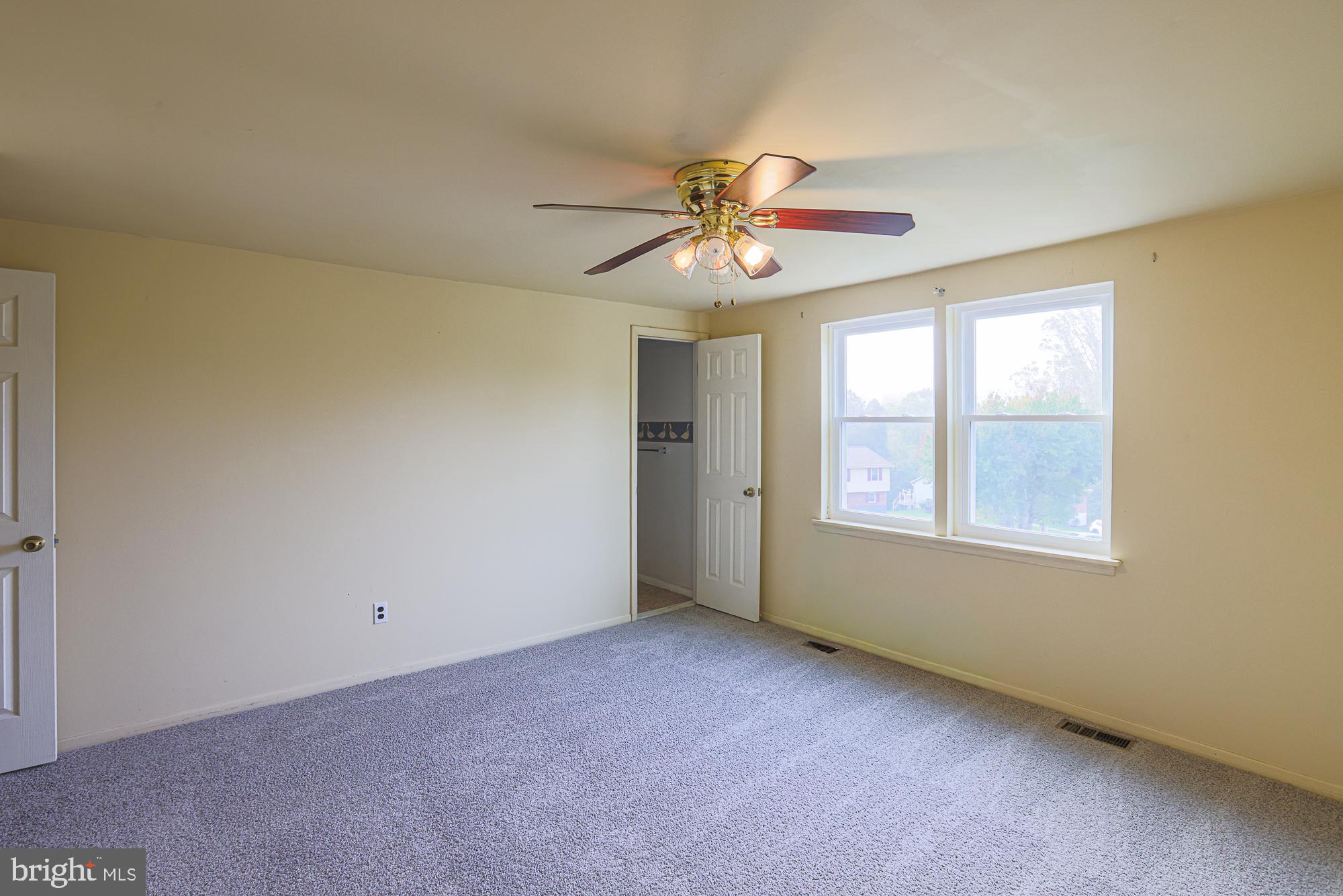 3923 Millner Road Baltimore, MD 21236 - Photo 16 of 38 an empty room with windows and fan