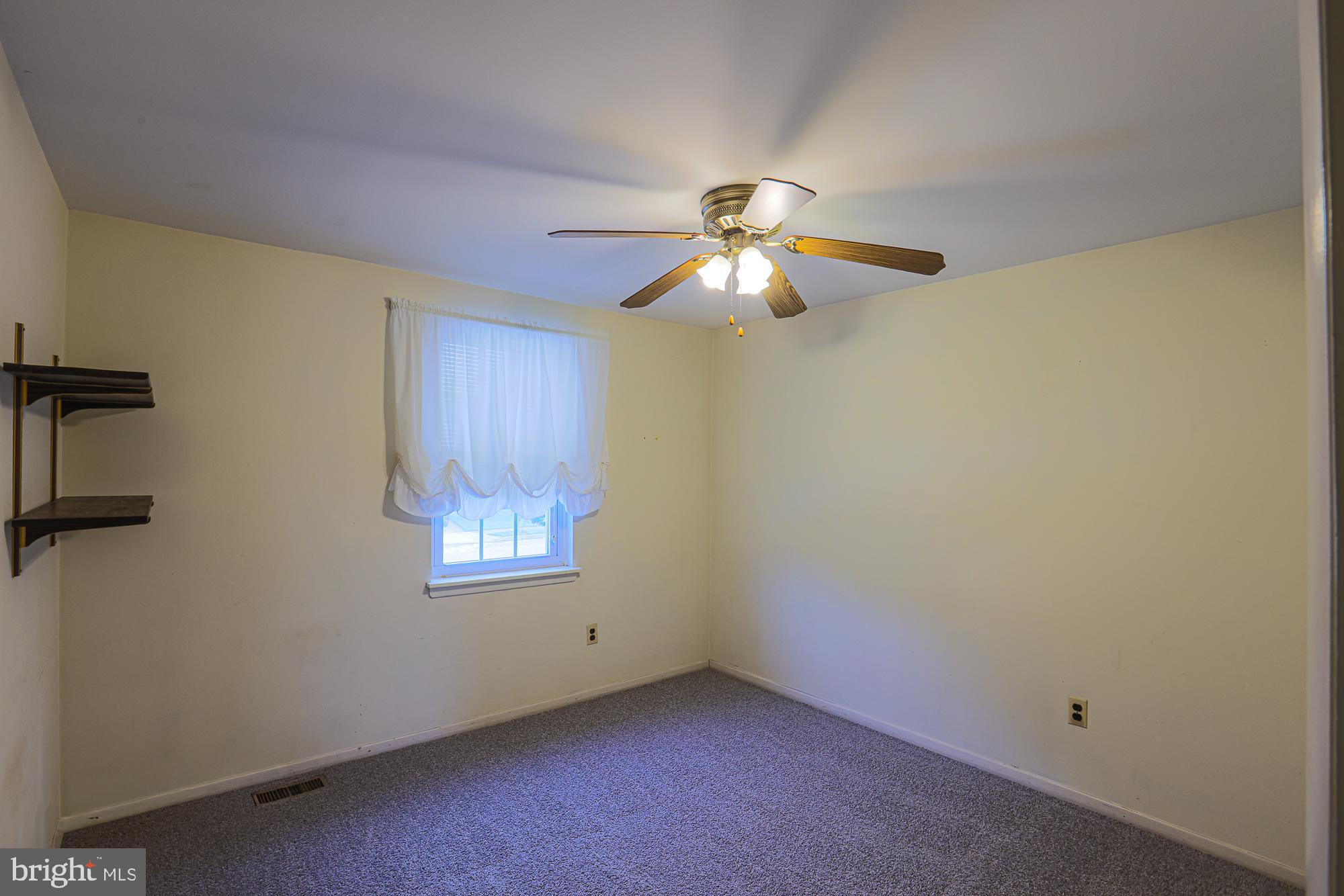 3923 Millner Road Baltimore, MD 21236 - Photo 21 of 38 an empty room with windows and fan