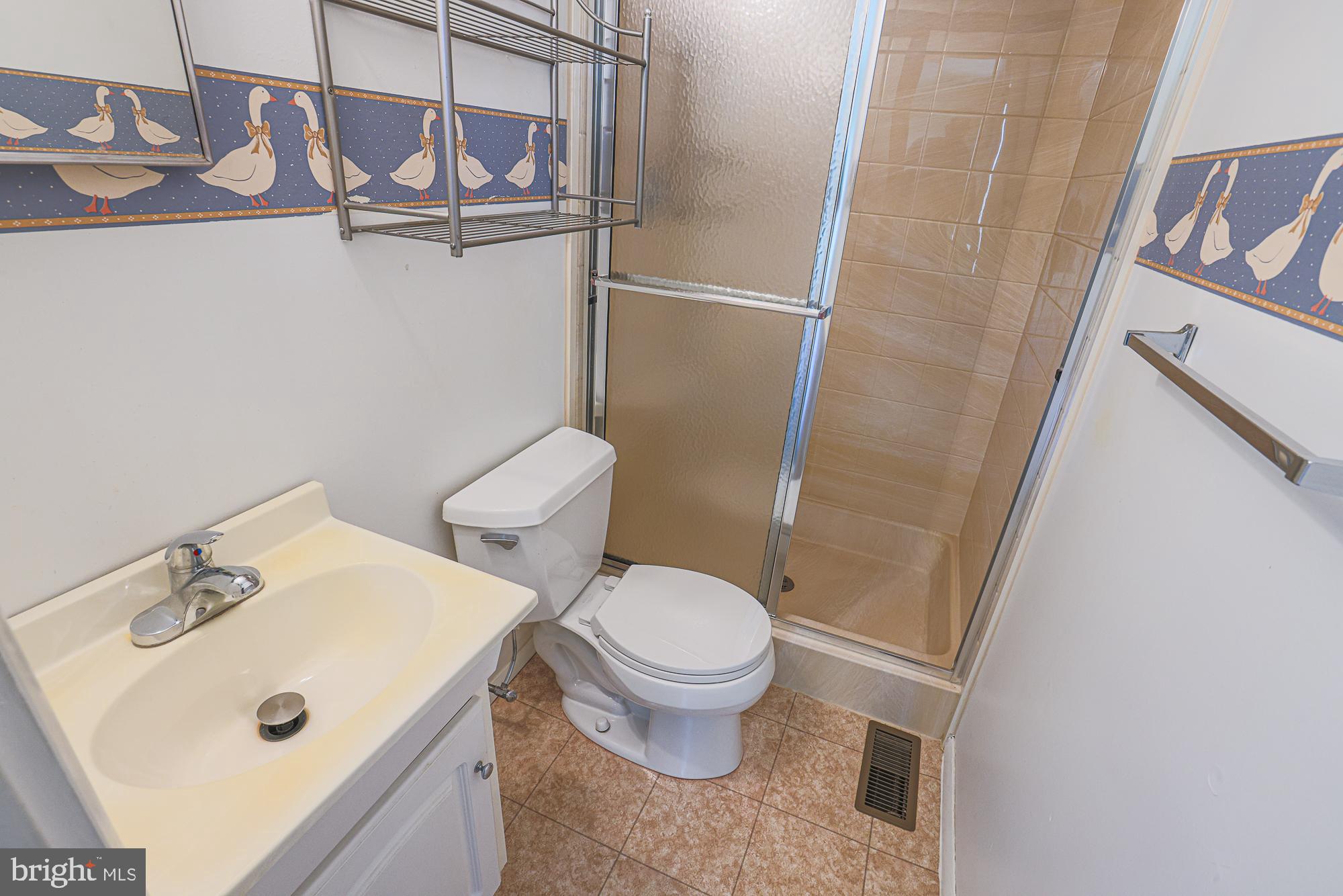 3923 Millner Road Baltimore, MD 21236 - Photo 25 of 38 a white toilet sitting next to a bathroom sink